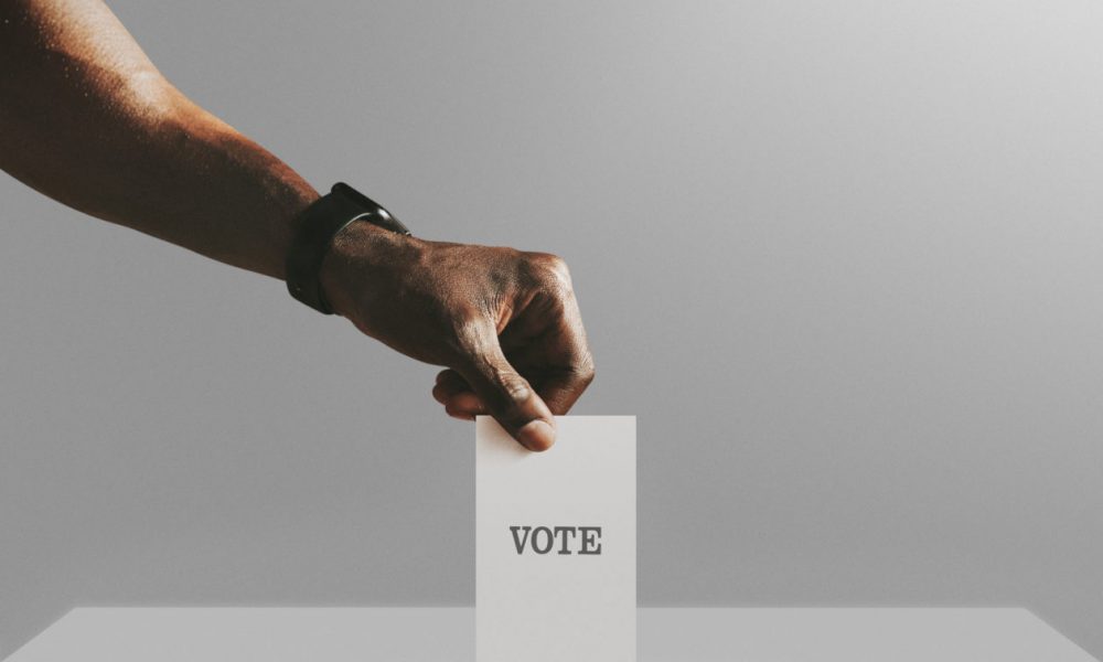 Man casting his vote to a ballot box mockup, quadratic funding can democratize community capital allocation