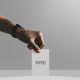 Man casting his vote to a ballot box mockup, quadratic funding can democratize community capital allocation