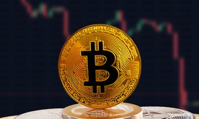 BTC on stack of cryptocurrencies with falling crashing graph in background