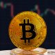 BTC on stack of cryptocurrencies with falling crashing graph in background