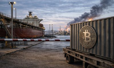 Bitcoin container halted at a port checkpoint as smoke rises in the distance, reflecting how escalating Iran war fears are weighing on the crypto market