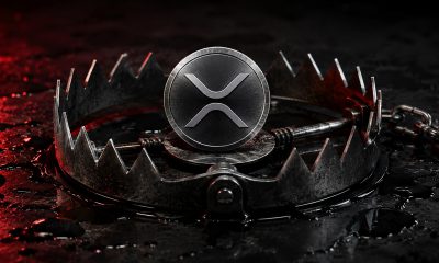 XRP token positioned inside a steel bear trap symbolizing rising leverage risk and tightening crypto market liquidity amid volatility fears
