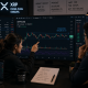 Traders analyzing XRP as it stays below $1.12